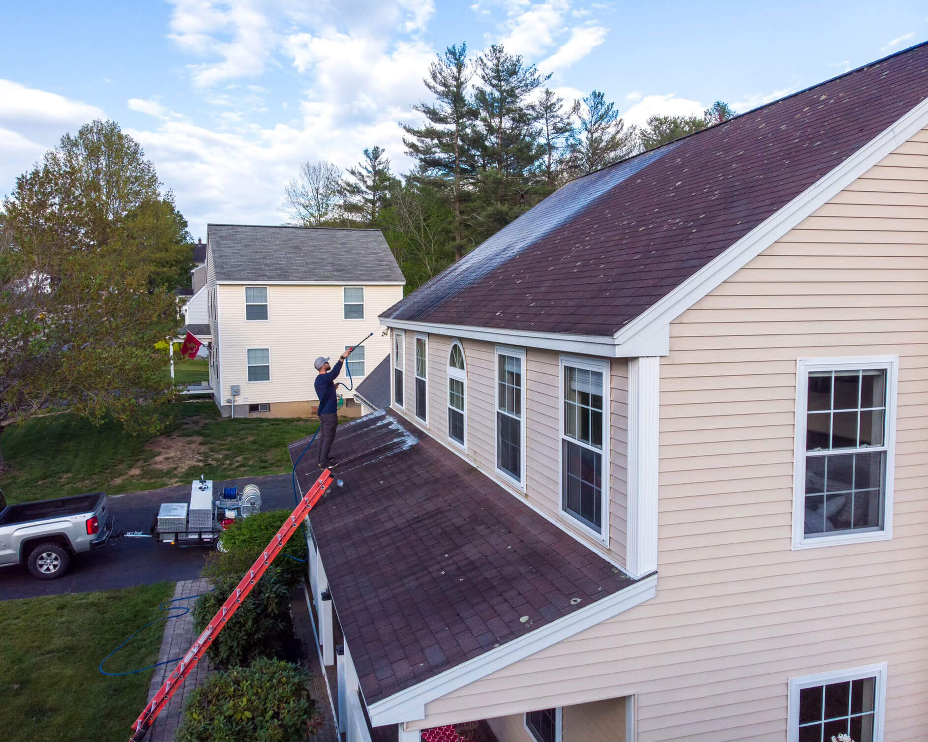 Roof soft washing in progress on a Cumberland home
